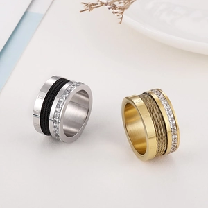 Detail of Roman numeral titanium steel rings with wire cable inlay and crystal stones