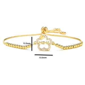 Close-up of golden adjustable mama bracelet with micro-pave flower charm and zircon accents