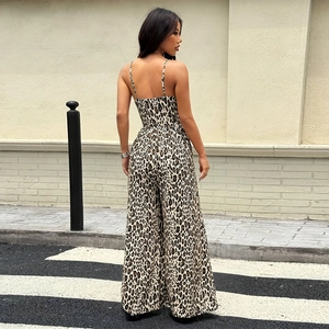 Back view of backless leopard print jumpsuit with thin straps and wide legs in street style