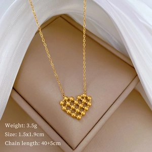Detailed view of gold heart pendant necklace on velvet box with weight and size specs