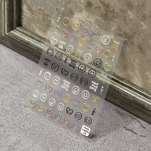 Detail of 3D embossed nail art stickers with colorful smileys and lucky slogans