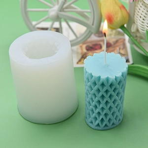 Cylindrical silicone candle mold with diamond grid texture and blue candle sample
