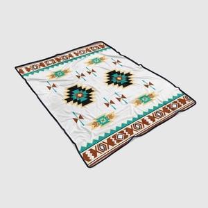 Detail of soft flannel blanket with tribal geometric patterns in teal and brown tones