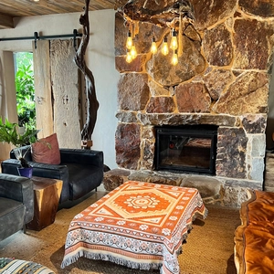 Bohemian orange woven picnic blanket with geometric mandala patterns and fringe tassels