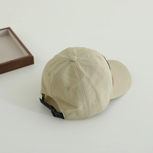 Close-up of laser-perforated side vents and adjustable strap on quick-dry sun hat