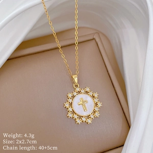 Detailed close-up of golden star cross pendant with mother of pearl and tiny diamonds