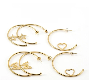Detailed macro view of 18K gold plated heart and butterfly charms on stainless steel hoops