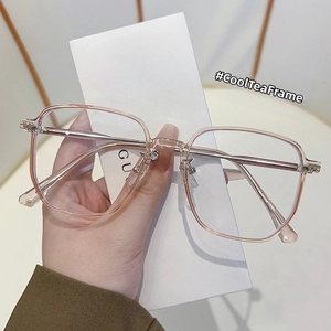 Detail of trendy tea-colored square eyeglass frames with slim metal temples