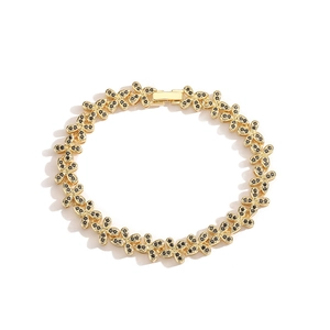 Detail view of gold butterfly bracelet with black micro-pave crystals on white backdrop