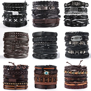 Stackable vintage leather bracelets set with metal charms for men on white background