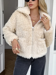 Detail of elegant beige faux fur jacket showing plush texture and wide collar lapels