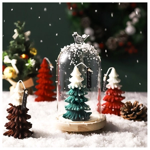 Detailed view of handmade Christmas tree candles with knitted texture on faux snow