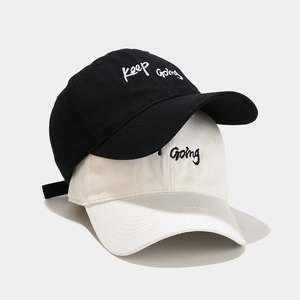 Classic cotton baseball caps in black and white with 'Keep Going' embroidery