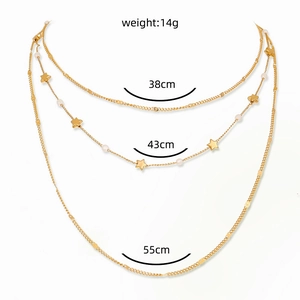 Macro view of multi-layer star necklace with pearls showing chain lengths and weight