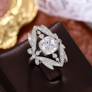 Macro shot of cushion cut crystal crown ring with silver-tone layered leaf design