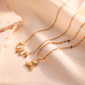 Chic teddy bear and shell pendant necklaces on silk with golden chain accents