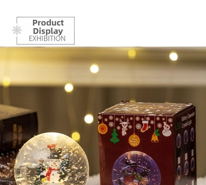 Close-up of LED Christmas snow globe featuring a snowman and festive red packaging