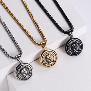 Detailed view of Queen Elizabeth II coin pendants in silver, gold, and black steel finishes