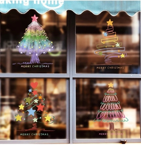 Detail view of colorful hand-drawn Christmas tree window stickers with Merry Christmas text