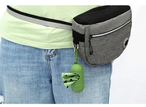 Gray canvas pet training pouch with green poop bag dispenser worn on waist