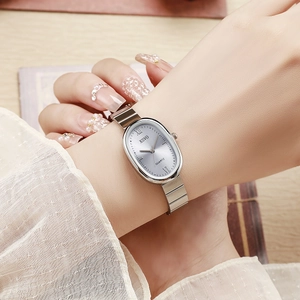 Women silver quartz watch with oval dial and bamboo-style steel strap on a model wrist