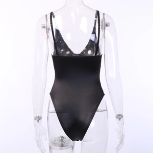 Detailed back view of a black backless bodysuit with thin straps on a mannequin