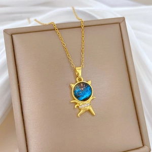 Starry cat necklace with blue stone and crystals in a beige jewelry box on white silk