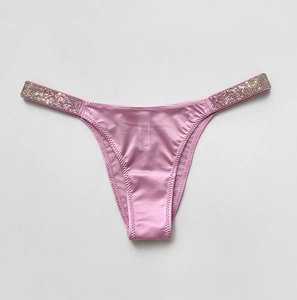 Detail of pink satin thong featuring sparkling rhinestone embellished side straps