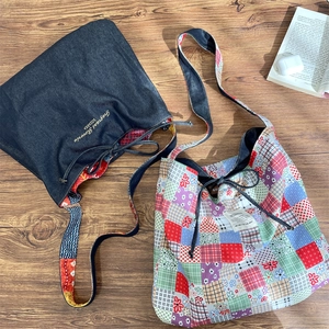 Macro shot of ethnic style patchwork and denim tote bags with embroidered details