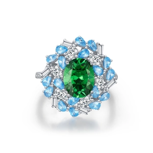 Vintage s925 silver ring featuring a large green emerald center stone and blue crystals