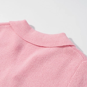 Close-up detail of the knit polo collar and shoulder on this pink short sleeve top