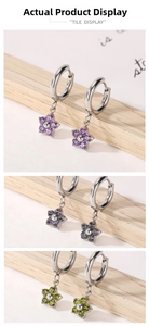 Detailed macro view of floral zircon earrings in purple, aurora, and yellow-green colors