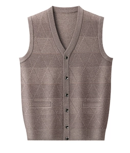 Detail of tan knit vest with diamond pattern, V-neck, and six dark buttons on white background