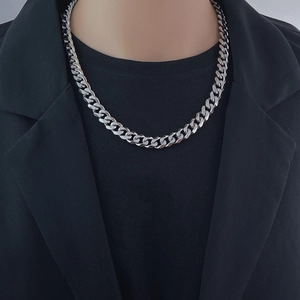 Silver Cuban link chain necklace shown on a model wearing a professional black suit