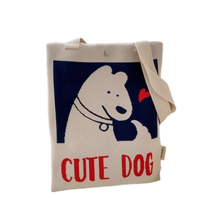 Beige knitted tote bag featuring a cute white cartoon dog pattern and shoulder strap