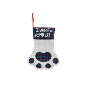 Detail of dog paw Christmas stocking with red plaid and I Woof You print text
