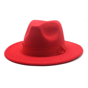 Detail of red wool felt fedora featuring flat wide brim and matching ribbon band