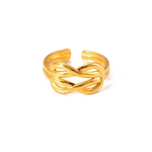 Macro detail of a golden braided knot open ring featuring a polished metallic texture