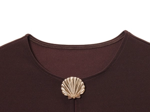 Close-up of golden shell-shaped buttons on dark brown vest with fine fabric texture