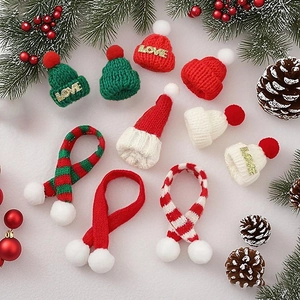Mini knitted Christmas hats and scarves set in red and green for festive DIY decorations