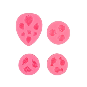 Set of 4 pink silicone fruit molds including strawberry pineapple and grape shapes