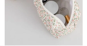 Detail of floral cosmetic bag showing spacious interior with skincare items