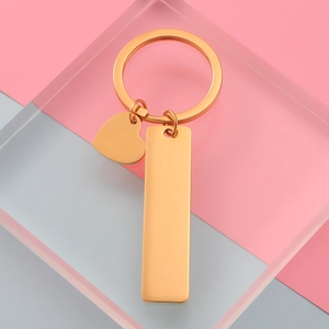 Minimalist gold metal keychain set featuring heart and rectangular bar pendants