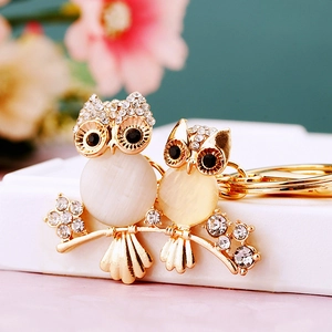 Macro shot of owl keychain with white cat eye stones and sparkling rhinestones
