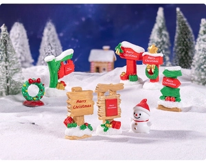Miniature Christmas snowman and Merry Christmas signpost in a snowy winter scene