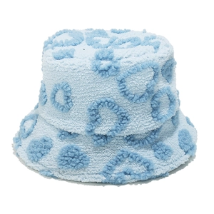 Detail of light blue faux shearling bucket hat with navy blue heart pattern