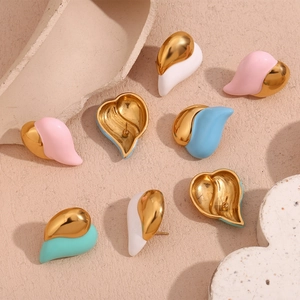 Detailed view of colorful heart stud earrings with enamel finish on stone surface