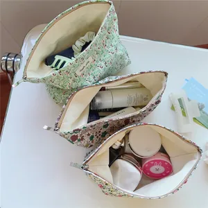 Detailed view of floral canvas makeup bags with zipper closure and large capacity
