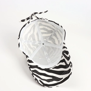 Detail shot of the zebra print baseball cap interior featuring cotton fabric and wash label