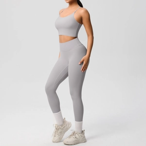 Side view of a grey high-waist yoga leggings and thin strap sports bra workout set